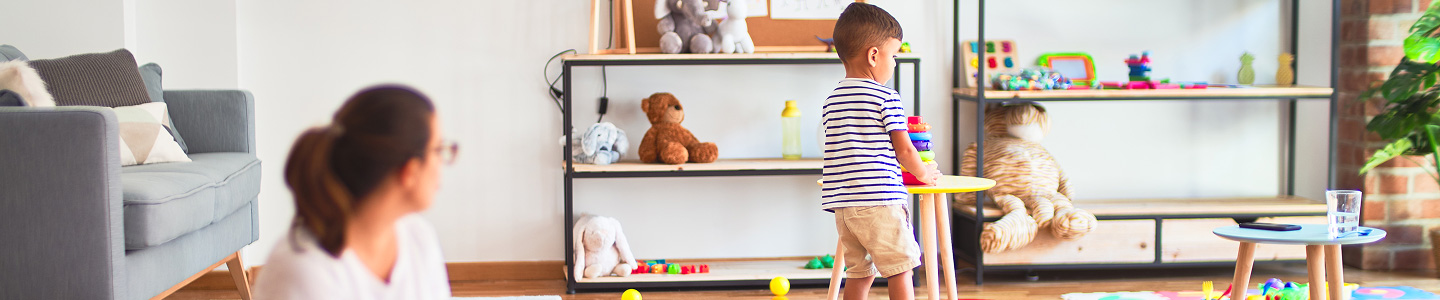 A kid playing independently bravely with a parent supervising