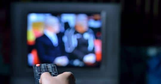 Man with anxiety watches politics on television