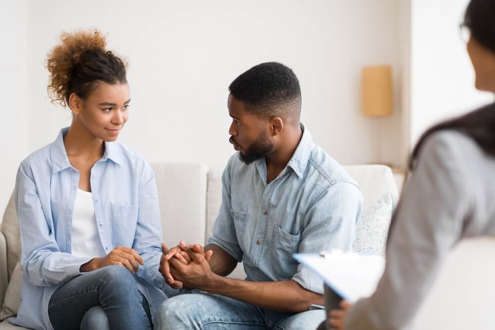 Couple holding hands in emotionally focused therapy session