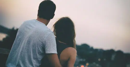 Romantic couple with arms around each other