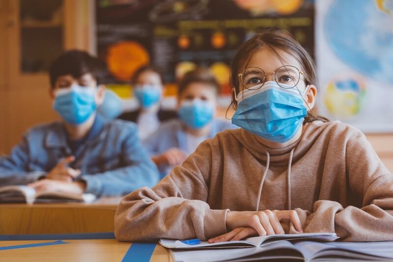 Classroom of children wearing face masks to protect from COVID-19 pandemic