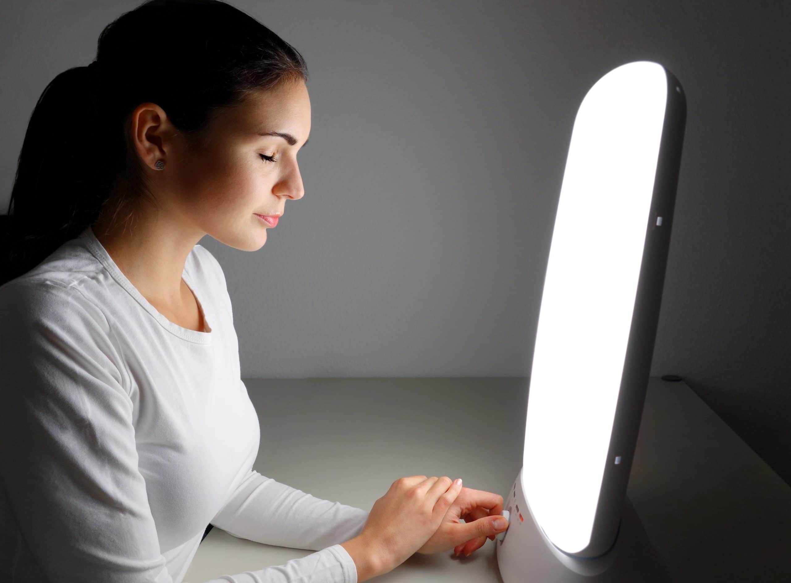 Woman spends time in front of therapy light to improve mental health