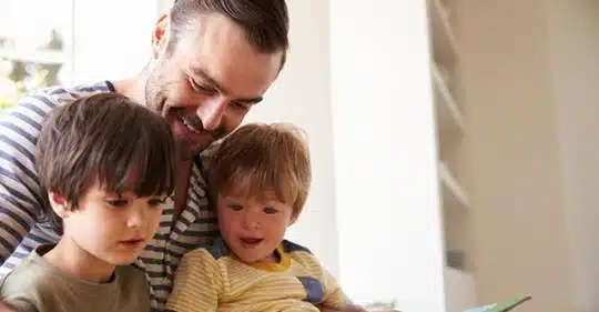 Father spends time with young children.