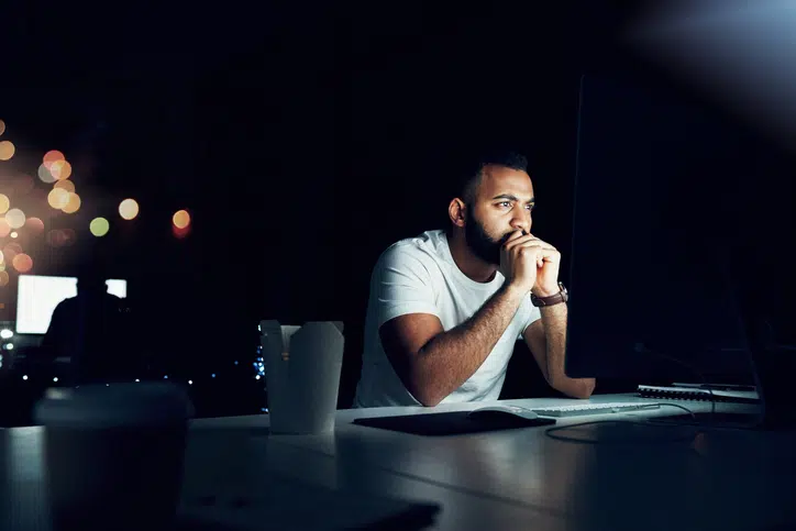 Man stares at computer worrying