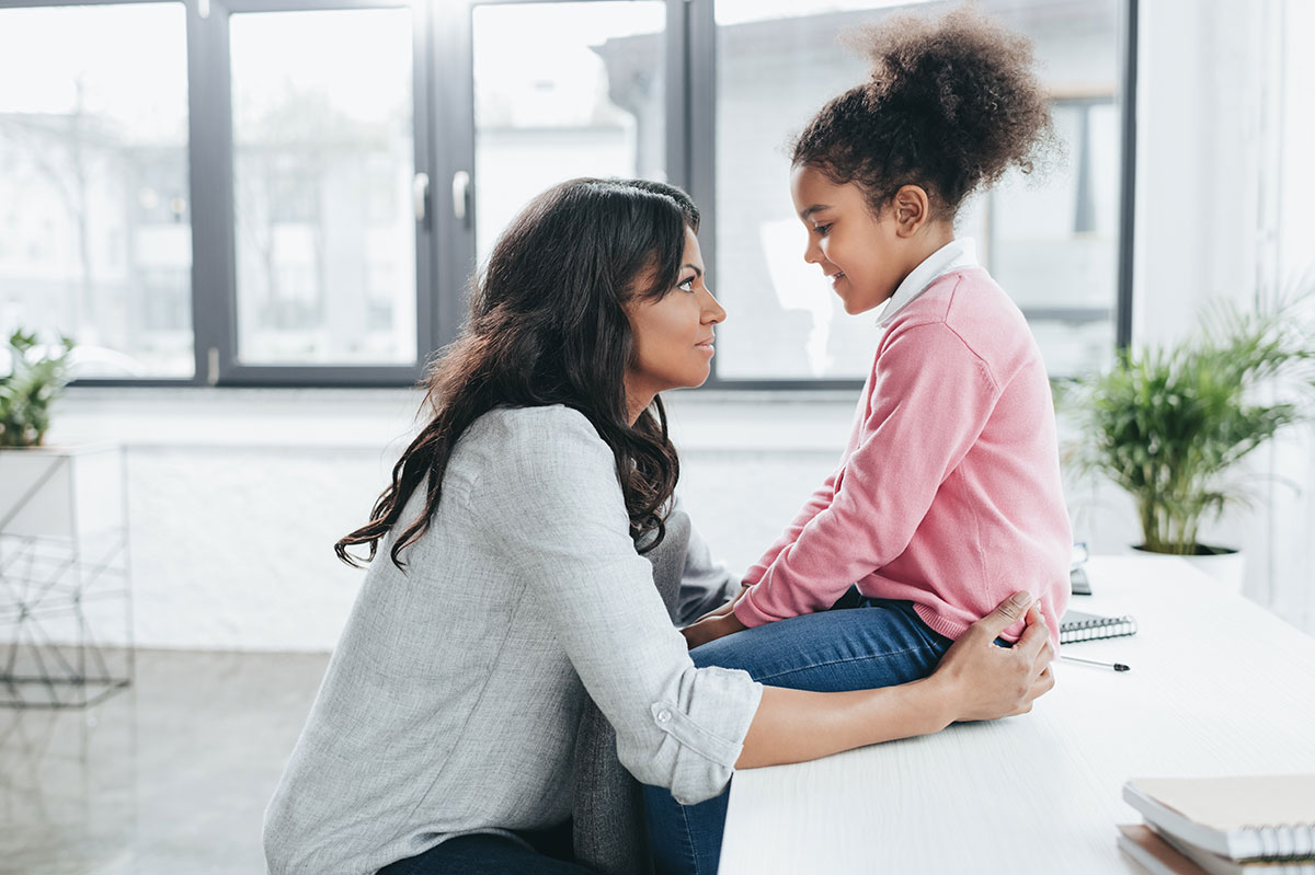 African American mother talking with daughter