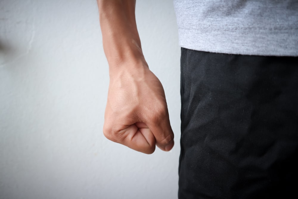 Closeup of clenched fist of angry man who needs anger management strategies
