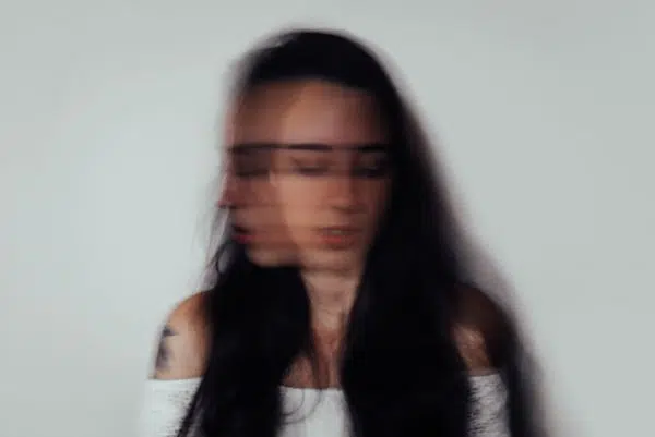 Person experiencing mental compulsions, racing thoughts, and internal anxiety
