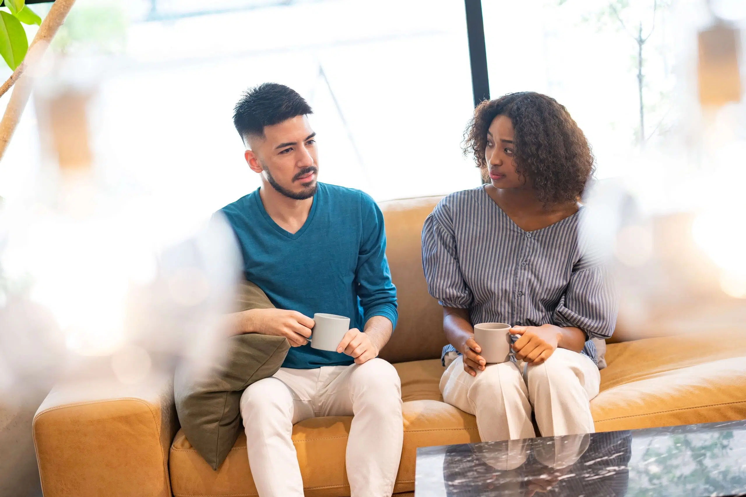 Two adults sitting together, reflecting different ways people experience closeness and connection in relationships.