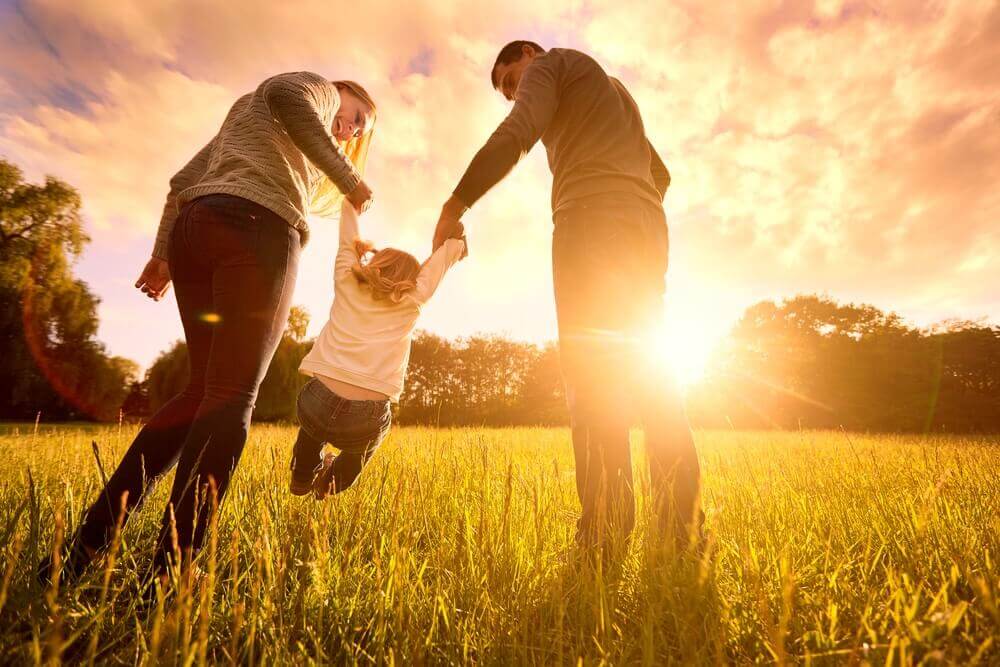 Parents playing with their child and fostering body positivity