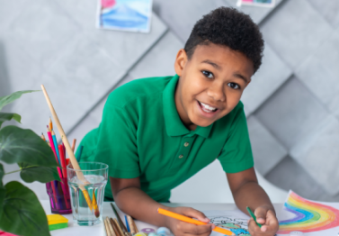 boy-standing-table-drawing-looking-camera-12-1-1