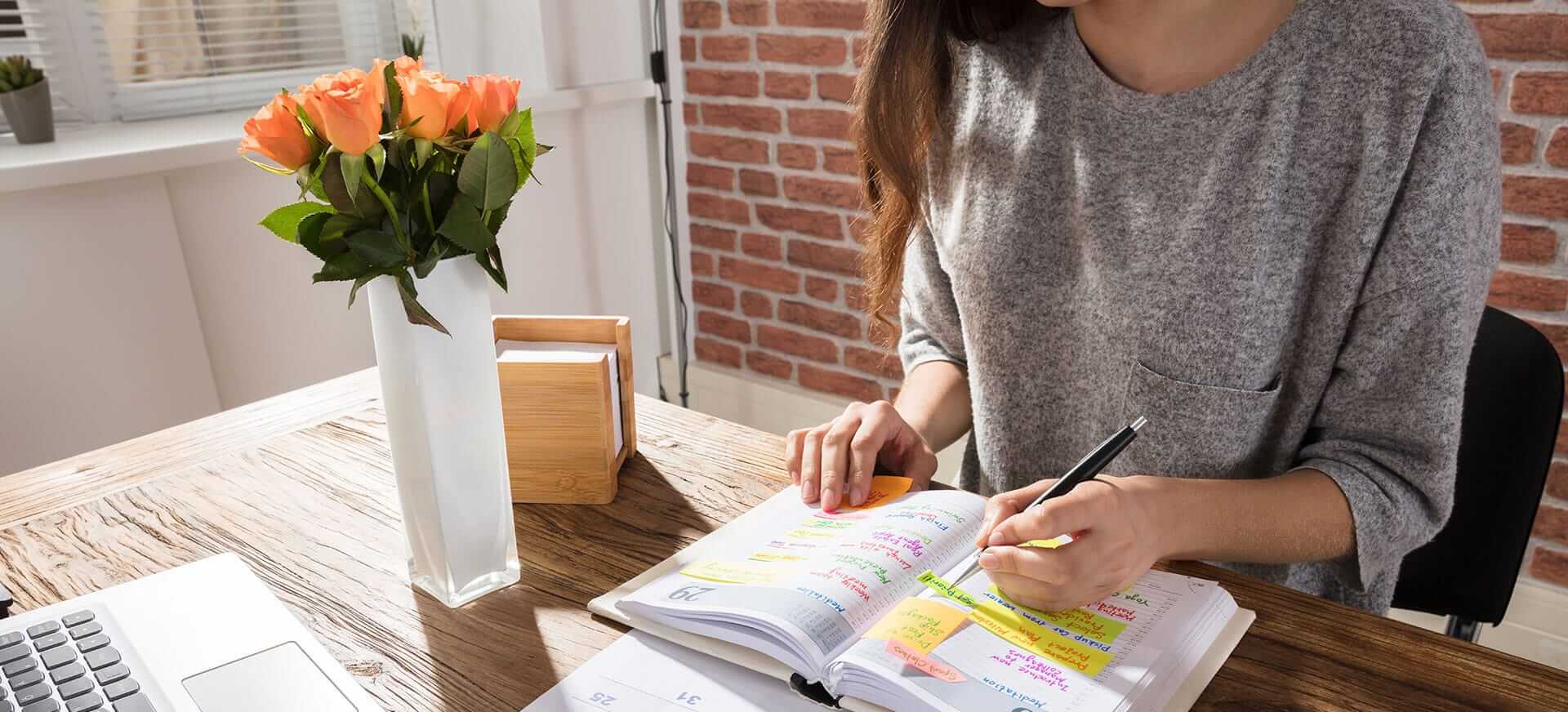 Woman works on calendars at desk