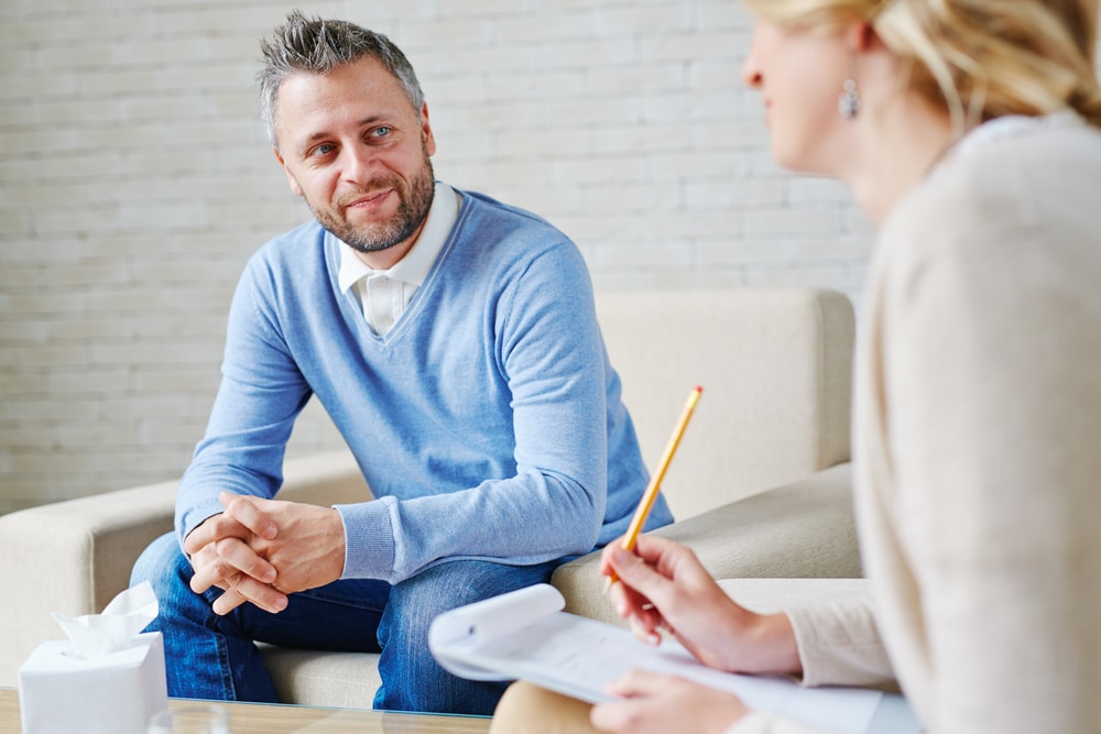 Man in therapy session using Cognitive Behavioral Therapy