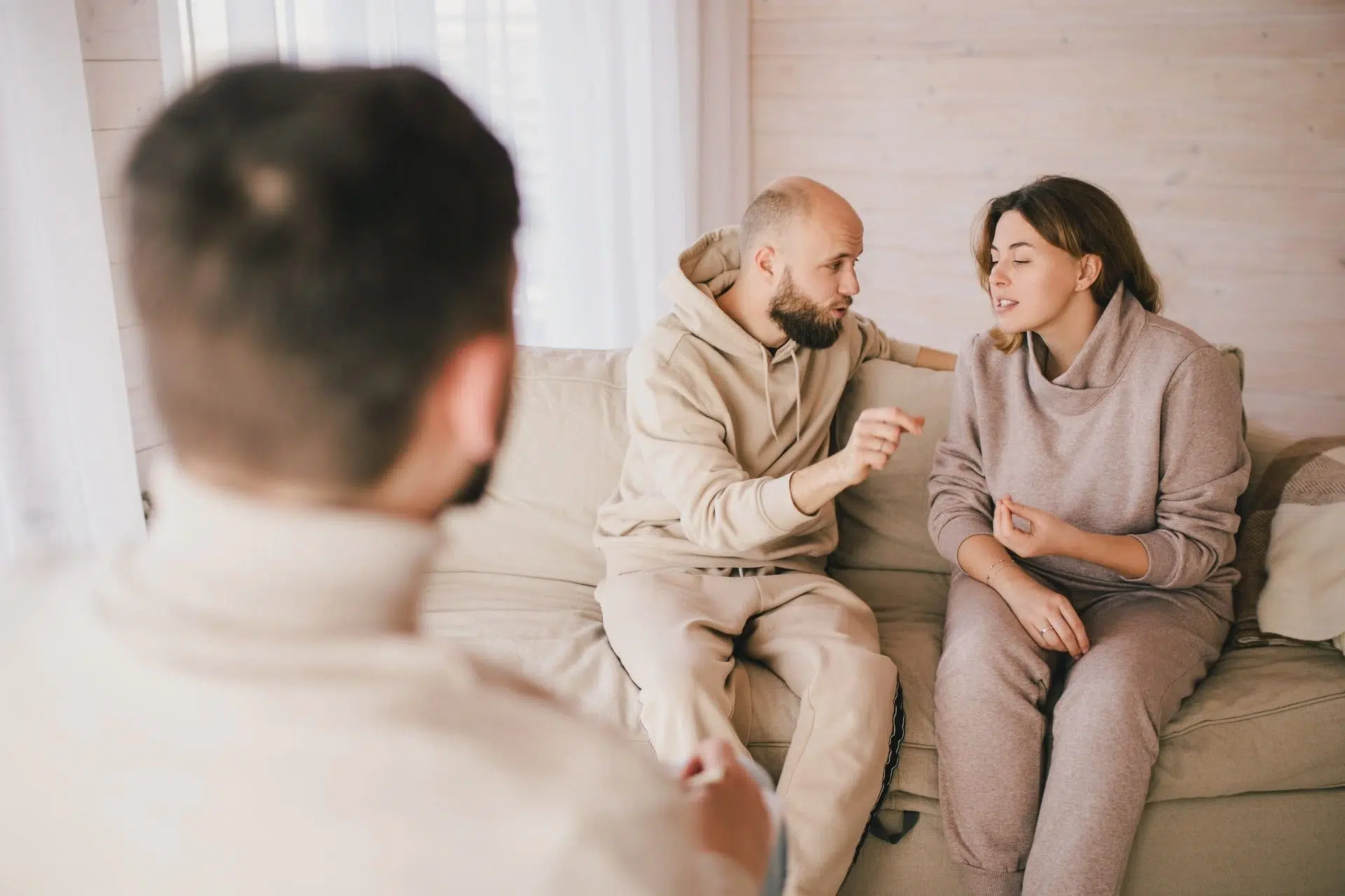 Couple communicating directly with each other during a therapist guided couples therapy session.