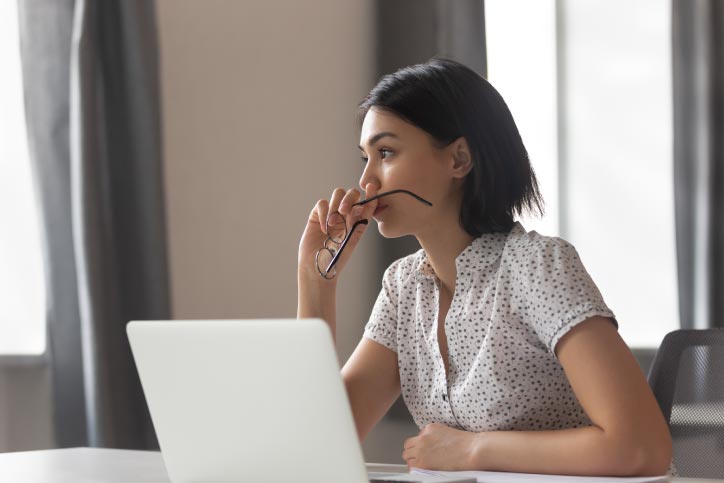Woman works on her computer with improved mental health from Eye Movement Desensitization & Reprocessing