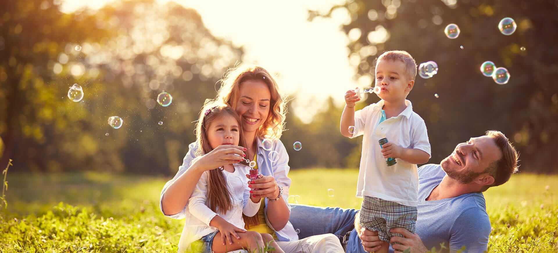 Family outside blowing bubbles