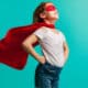 Confident little girl wearing a superhero outifit