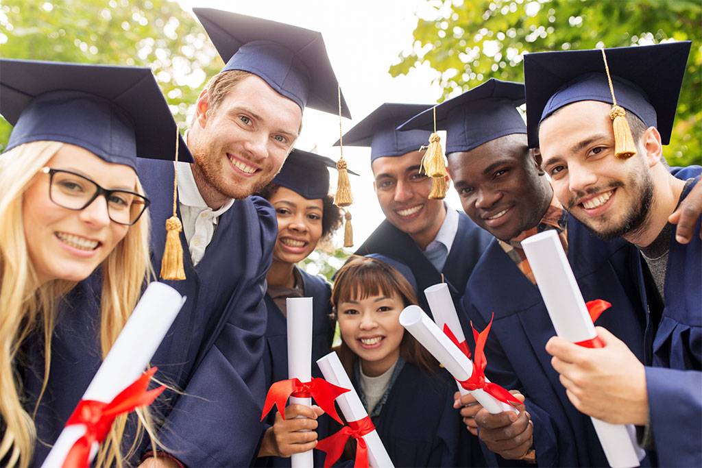 Happy students in mortar boards