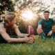 Couple stretching after exercising outdoors for mental health