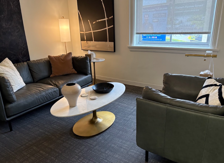 Therapy lounge with leather sofas and warm lighting at the Lukin Center Englewood office