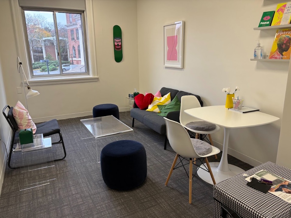 Bright group therapy room with seating and a table at the Lukin Center Englewood office