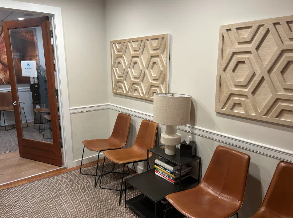 Waiting area with leather chairs and textured wall art at the Lukin Center Hoboken office