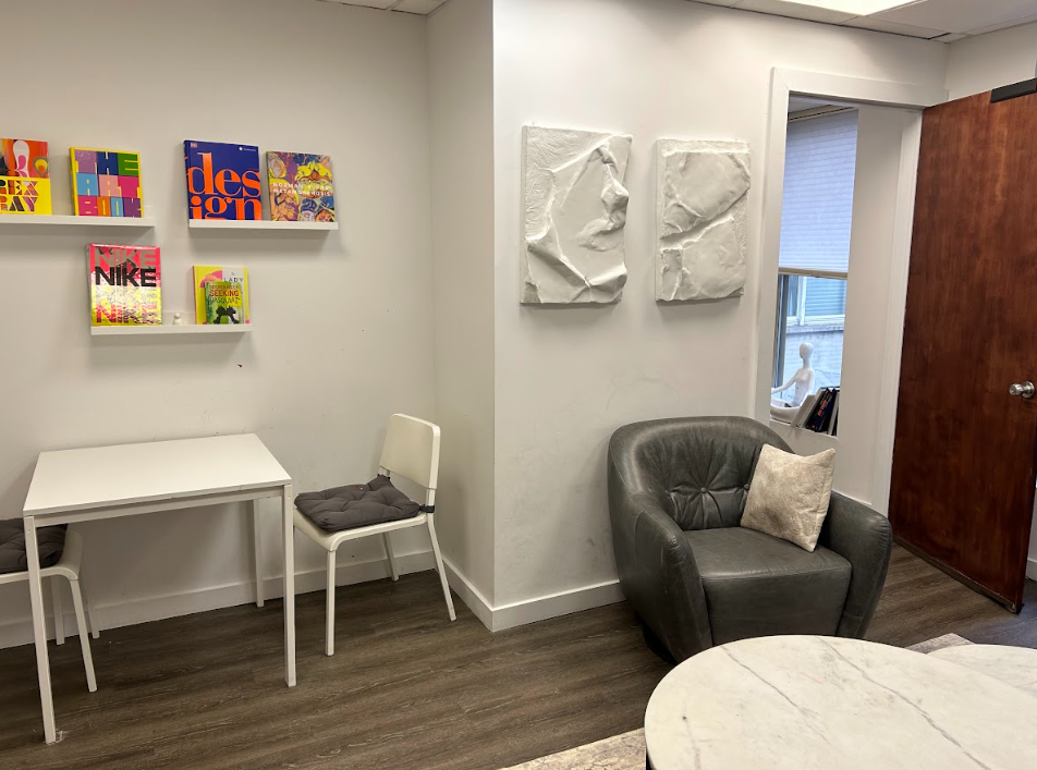 Child and play therapy room with a small table and colorful book display at the Lukin Center Hoboken office