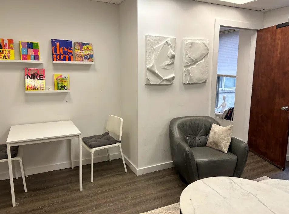 Child and play therapy room with a small table and colorful book display at the Lukin Center Hoboken office