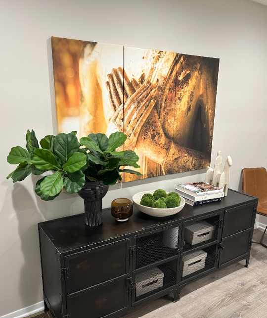 Therapy office with a console, plant, and wall art at the Lukin Center Westfield office