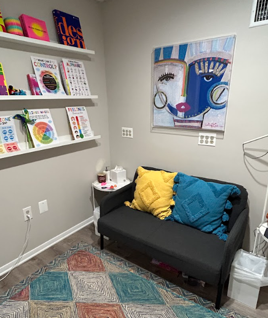 Child and play therapy room with colorful books and seating at the Lukin Center Westfield office