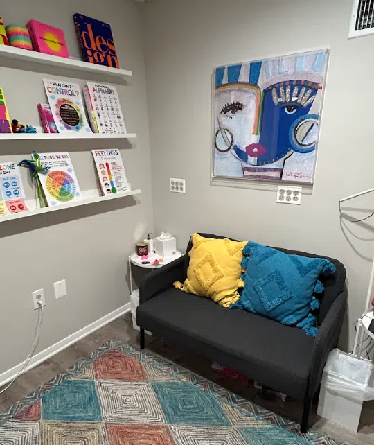 Child and play therapy room with colorful books and seating at the Lukin Center Westfield office