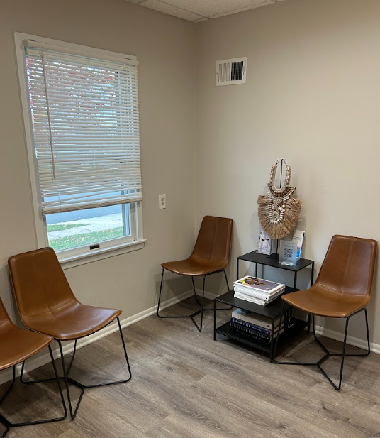 Waiting area with leather chairs and a window at the Lukin Center Westfield office