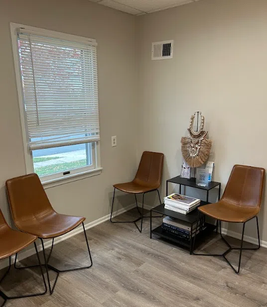 Waiting area with leather chairs and a window at the Lukin Center Westfield office
