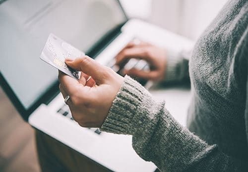 Woman pays for invoice on laptop