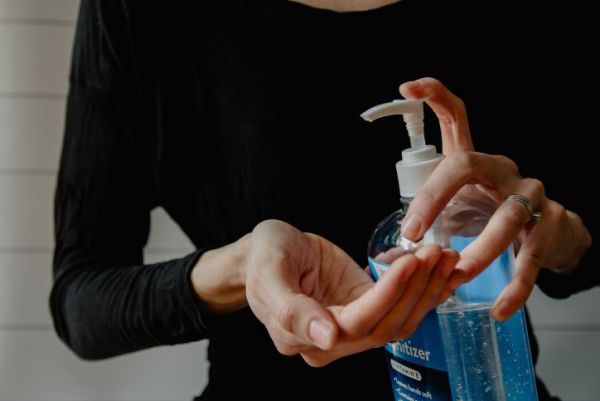 Person struggling with OCD sanitizes hands.