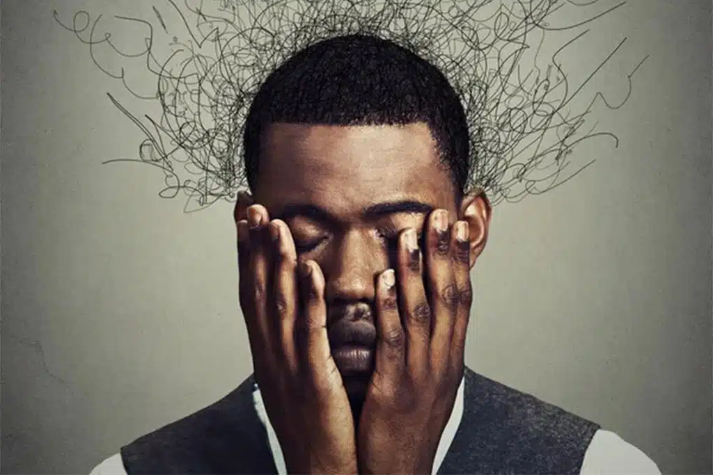 Man holding head in hands with tangled lines representing mental compulsions and overthinking
