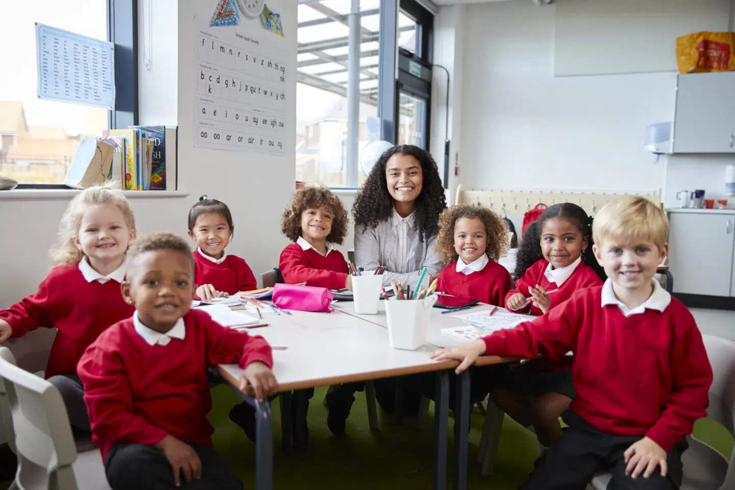 portrait of infant school teacher and kids sitting 2024 10 22 13 10 07 utc
