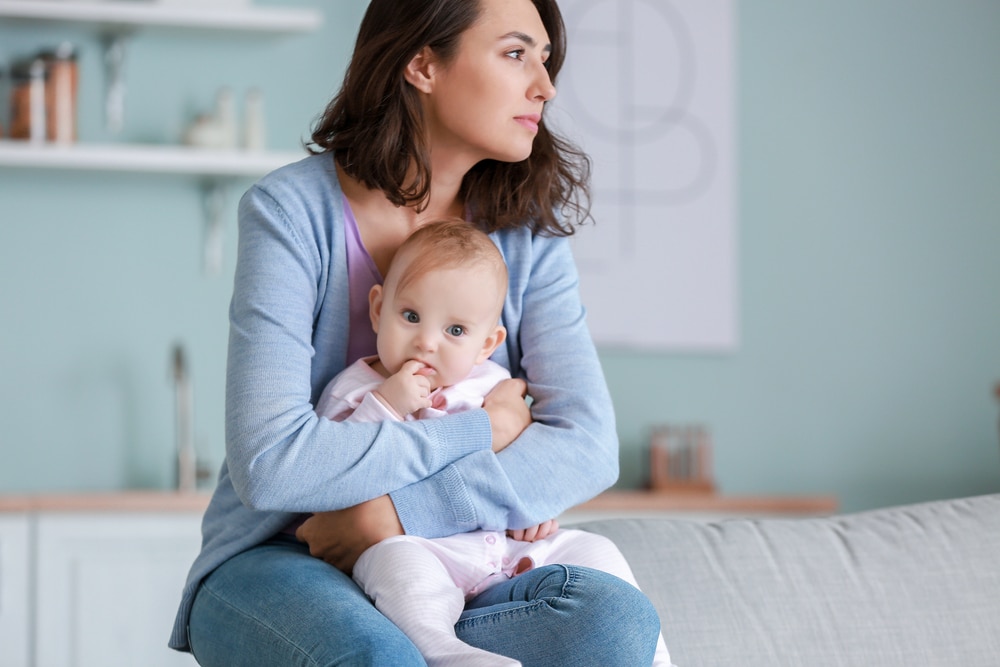 Mom holds baby while suffering with postpartum depression