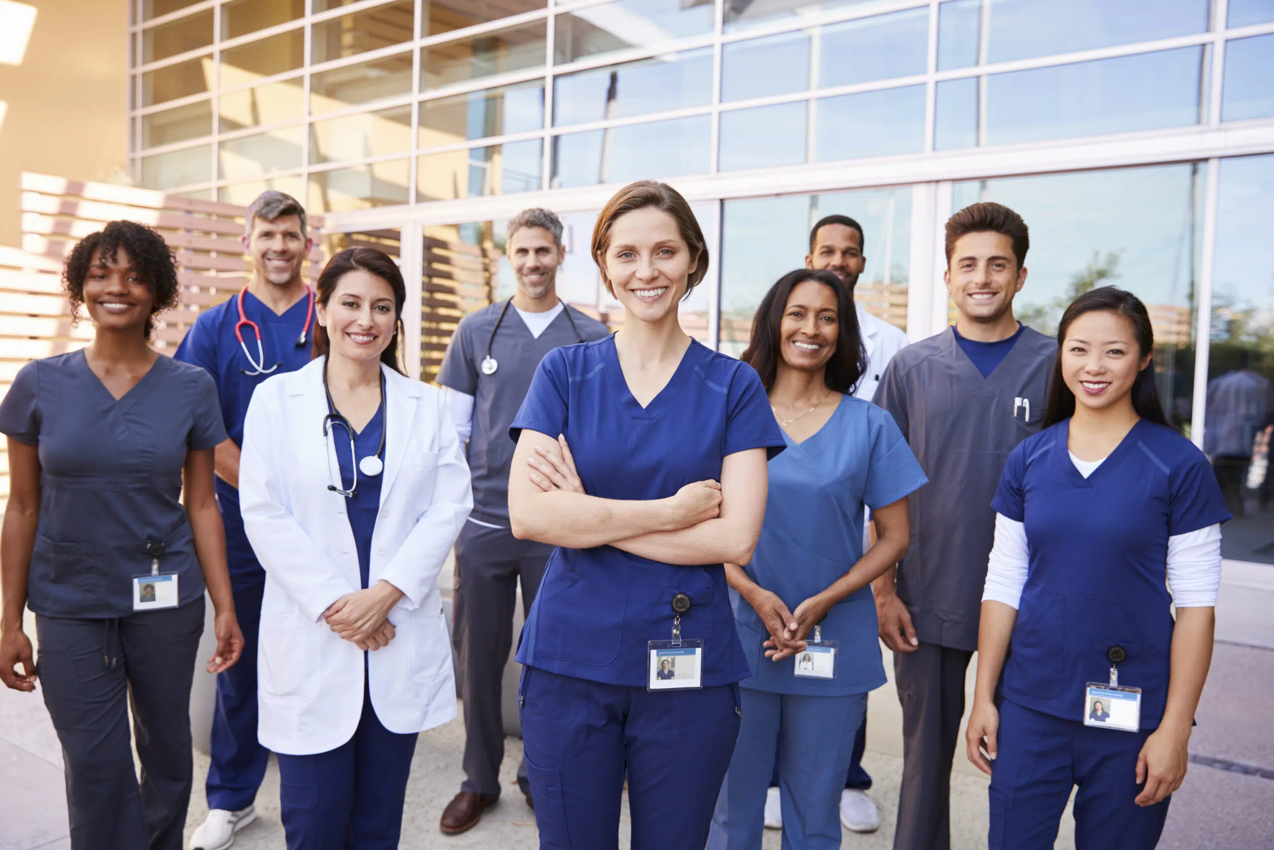 team of healthcare workers with id badges outside 2024 10 19 05 24 25 utc scaled
