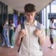 A teenage boy at school with his head down looking sad for the topic back-to-school anxiety.