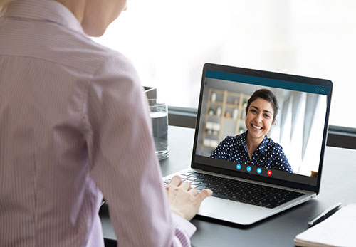 Person receives teletherapy on laptop