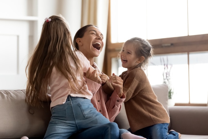 Happy mom plays with kids to heal after the pandemic