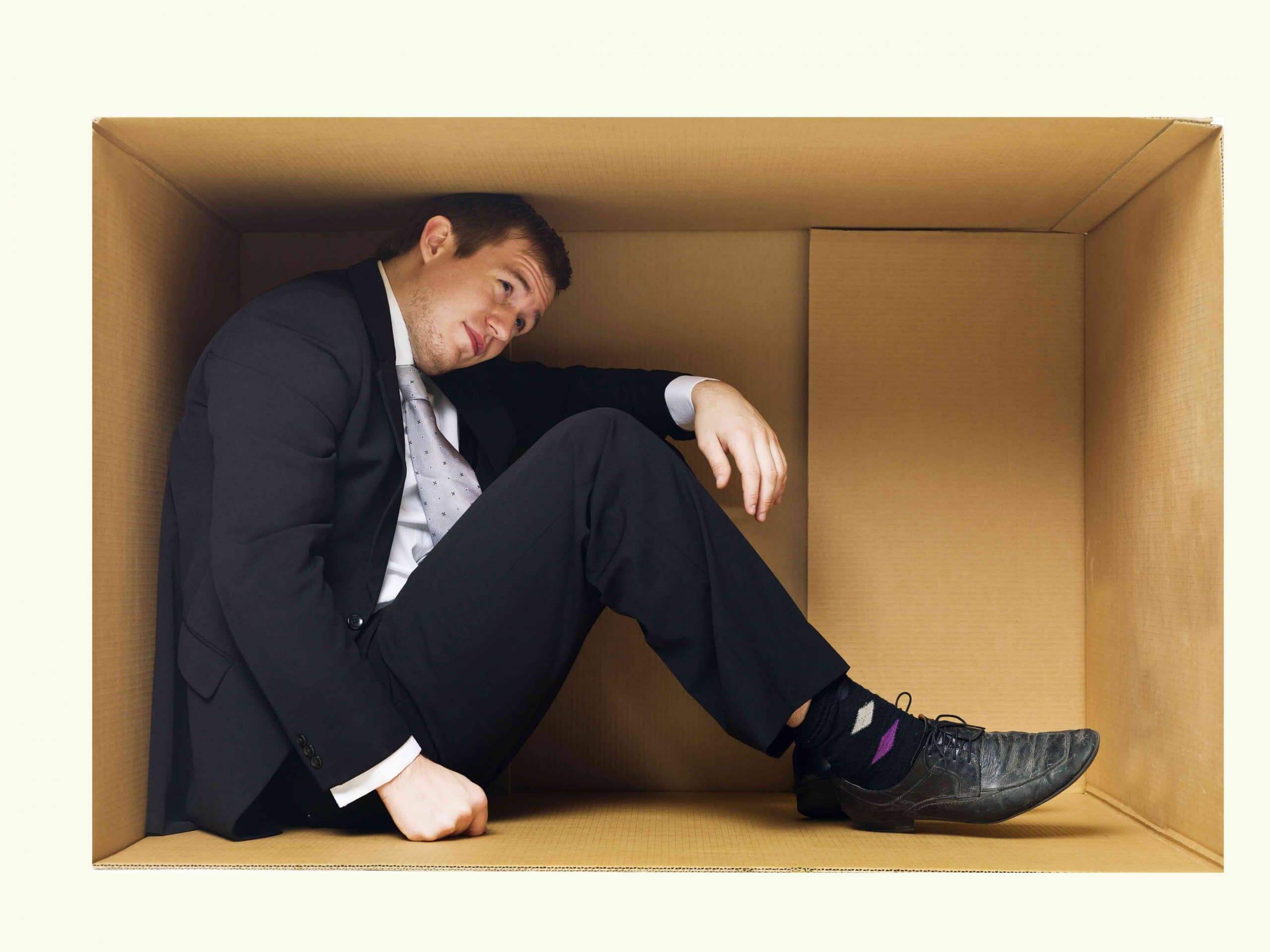 Businessman in box suffering from work stress